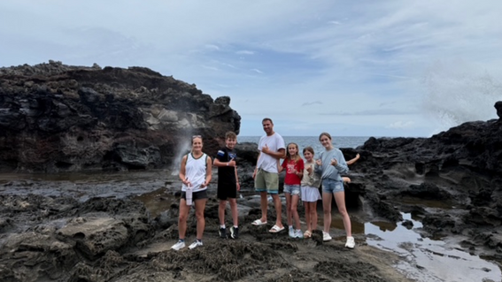 Caiya and her family on a costal rock