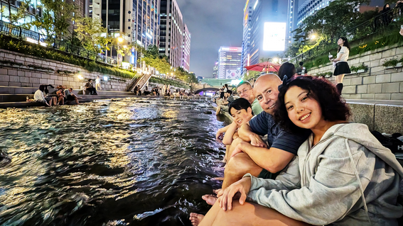 Zoey with her younger brother, Dylan, and dad, Jeremy, at a river near their hotel