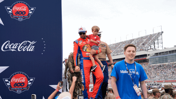 Caleb walking with a racecar driver