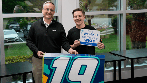 Caleb holding a wish sign