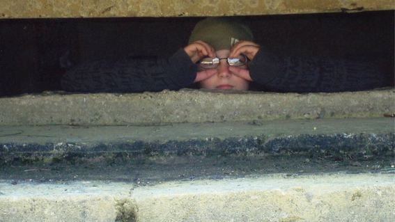 Conrad peers out of a World War II-era bunker. 