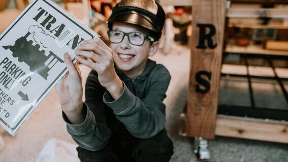 Honour holding Train sign
