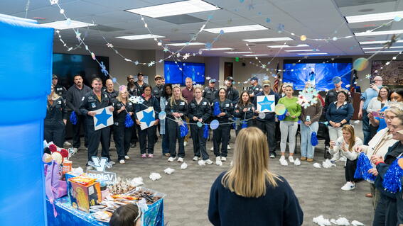 Group of people surrounding a child