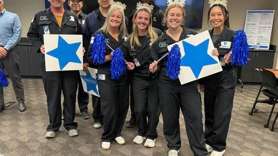 Employees standing with signs