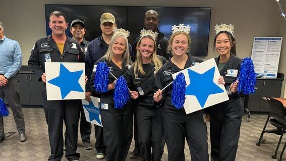 Employees standing with signs