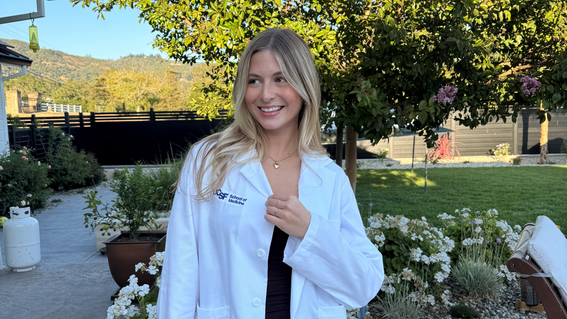 Isabella smiles proudly at her white coat ceremony at UCSF in 2025—a meaningful milestone for first‑year medical students.
