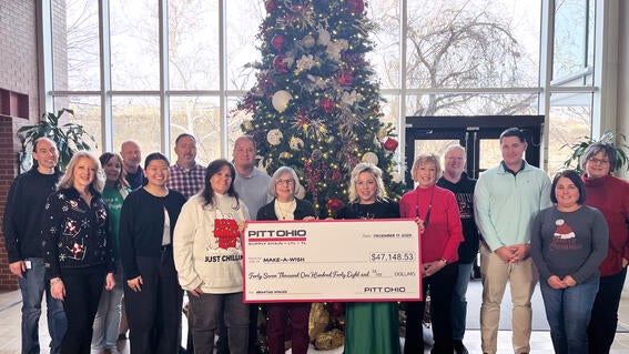 Pitt Ohio Employees present Make-A-Wish Director of Development, Stephanie Pugliese with a donation to local wishes