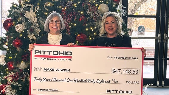Candy Cybator, Manager of Marketing and PR at PITT OHIO and Make-A-Wish Director of Development, Stephanie Pugliese hold up a giant check for wish granting.