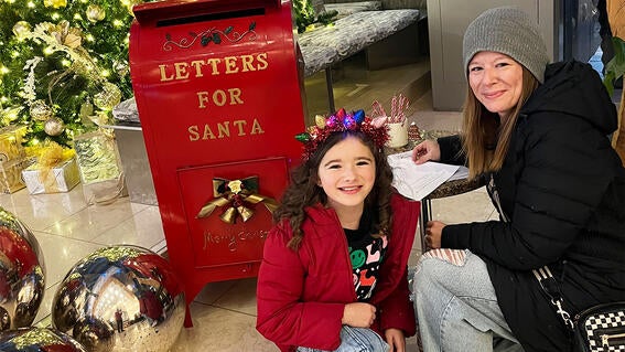 Wish kid Scout and her mom writing letters to Santa. 