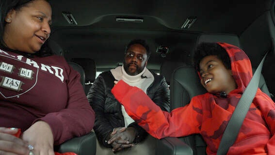 Austin and his parents in the car