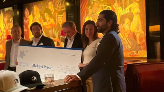 Bisnow employees presenting a donation to Make-A-Wish North Texas