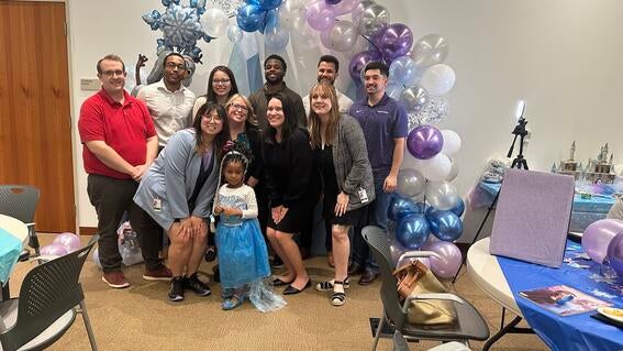 employees smiling with wish kid