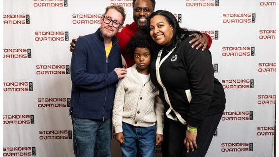 Austin is smiling with Macauley and his parents