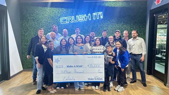 Zinfinity employees smiling with Make-A-Wish wish kid and employee