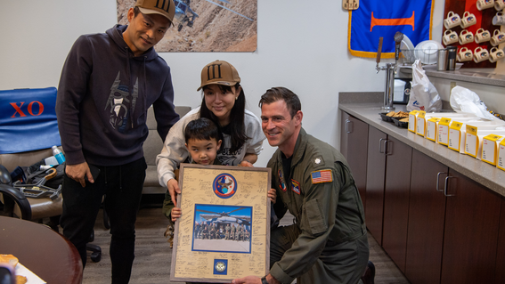 The commander presenting Ringo with a framed photo signed by everyone he had met.