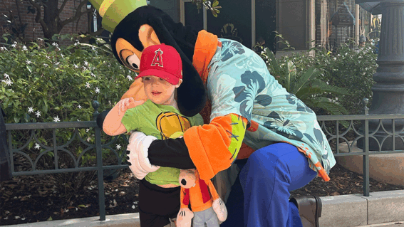 Lucas hugging Goofy