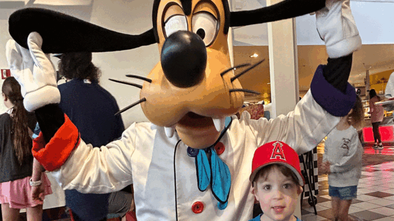 Lucas smiling next to Goofy