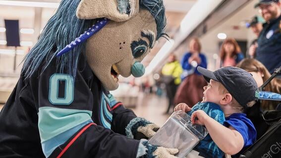 Buoy and Caleb smiling at each other at the airport