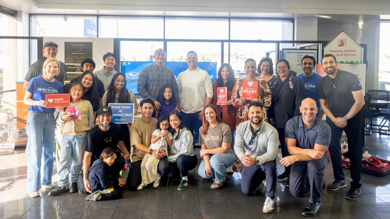 Bella and family with the Capital Subaru staff during her wish reveal.