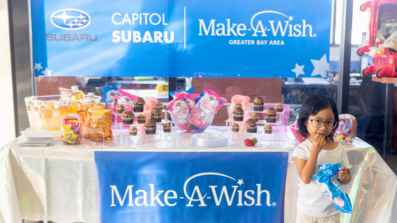 Bella, with all her favorite treats, at her wish reveal at Capital Subaru 