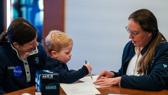Caleb signing his one-day contract with the Kraken