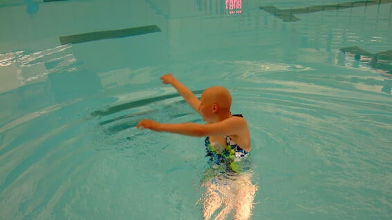 Lenka in the pool with family