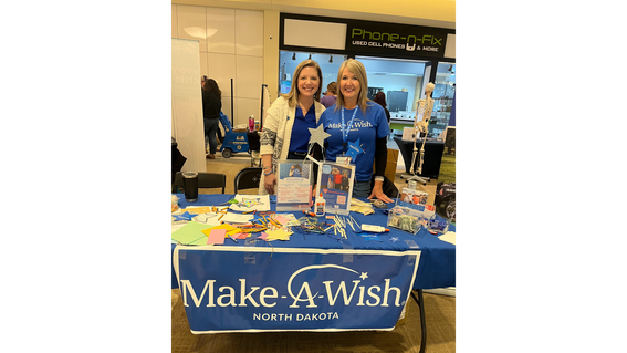 Volunteers Kristen and Charla at a booth