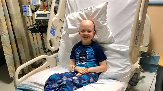 wish kid Ben during his medical journey, sitting in a hospital bed - photo 1