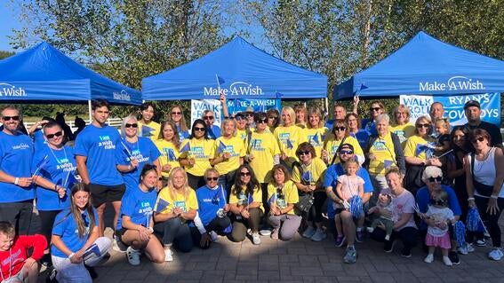 Image shows a group of volunteers posing for a photo