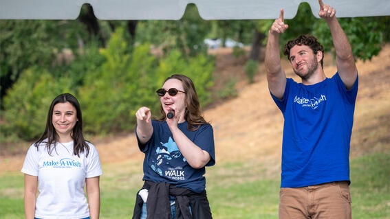 Milan, Rachel, and Matthew on the stage at Walk for Wishes