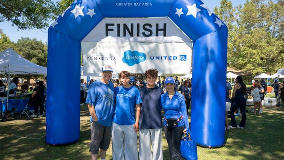 Wish kid Devan and family pose at the finish line