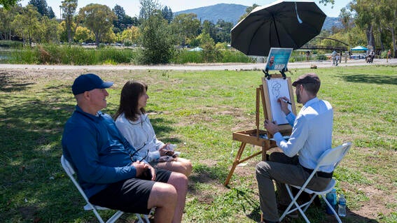 Caricature artist captures the likeness of two Walk attendees