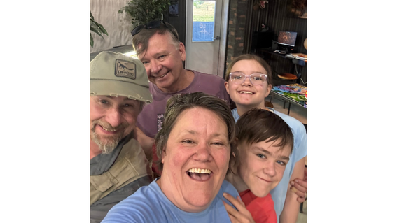 Ian and family pose for a selfie with their dino dig guide, Walter