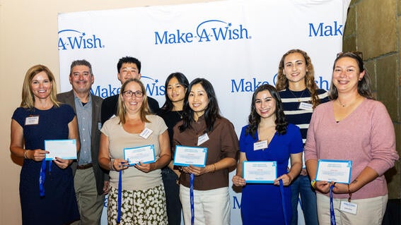 From left to right: Amy Hofmann, Bryan and Andrea Vaughn (accepting on behalf of their daughter, Amy Vaughn), Cooper Lee, Maika Ting, Viola Sutanto, Milan Alas, Lindsey Fontenot, and Andrea Alford.