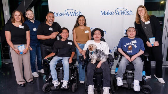 Wish kid Christian and family center, with Unlock Hope Innovation award winners Lisa Allie on the left and Christa Steiner on the right.