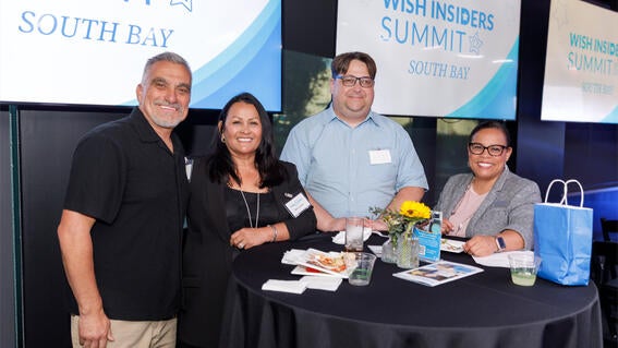 Wish It Forward Full Circle Award Winner Nick Duguid, center right, with Make-A-Wish staff member Samantha Seals on the right