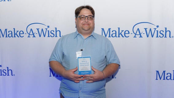 Wish It Forward Full Circle Award winner Nick Duguid holding their award
