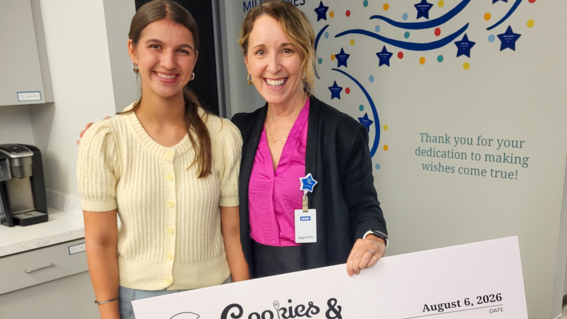 Wish alum Neysa presents donation check to Casey Marsh, CEO