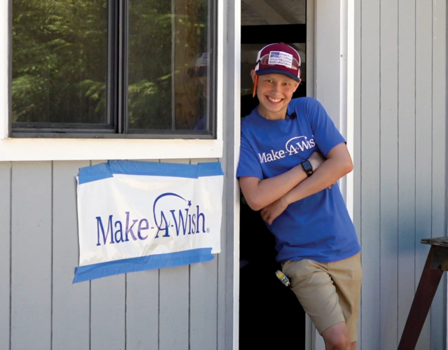 Keegan stands outside of his woodshop