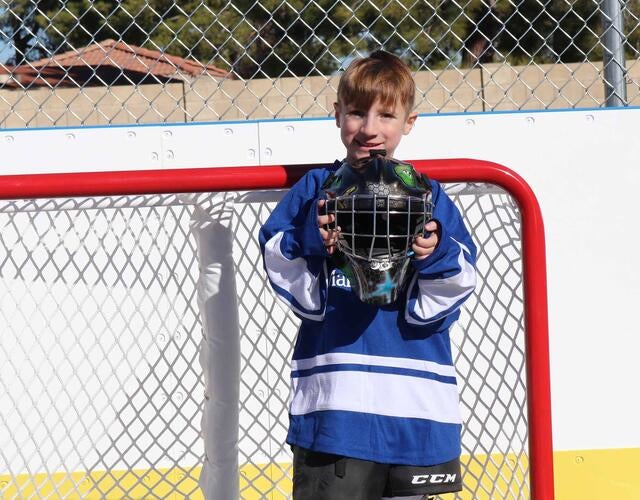 Max is ready to play on his backyard hockey rink wish