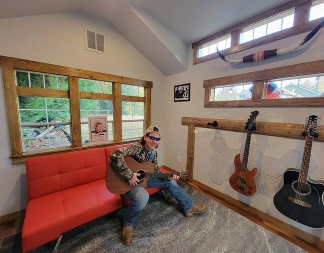 Billy playing guitar in his new studio shed
