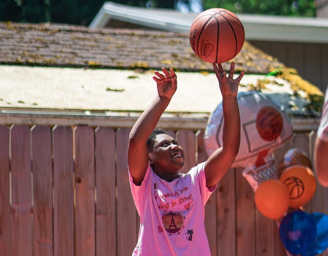 Audrianna Shooting a Basketball