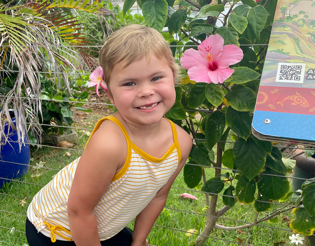 Charlotte poses with a flower in her hair during her wish to visit the island of Hawaii.