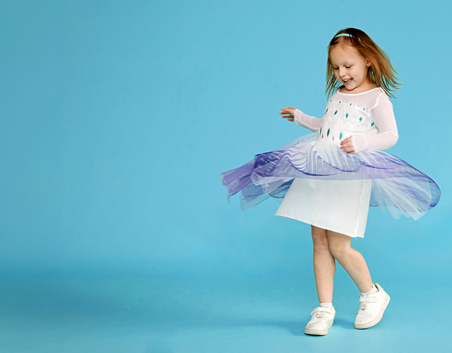 girl with red hair twirling in skirt