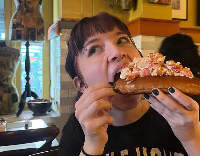 Roux eating a sandwich in New York
