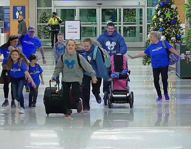 Two wish kid girls running to their airplane in the terminal