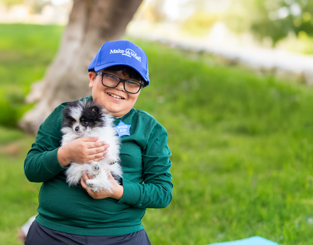 Dylan holds his Pomeranian puppy.