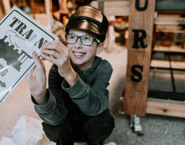 Honour holding Train sign