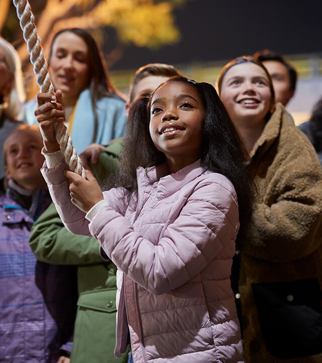 Young girl surrounded by community