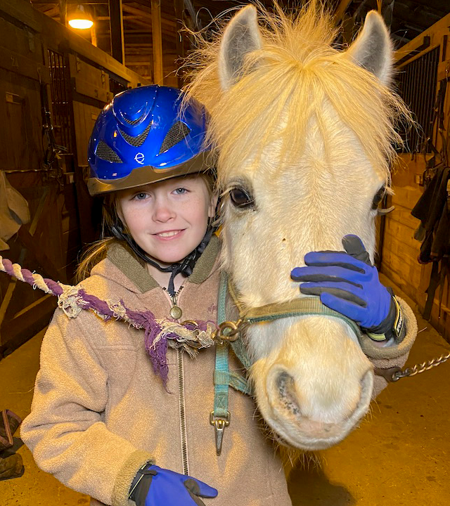 Elizabeth with her white horse, Prince Aladdin, in the barn.